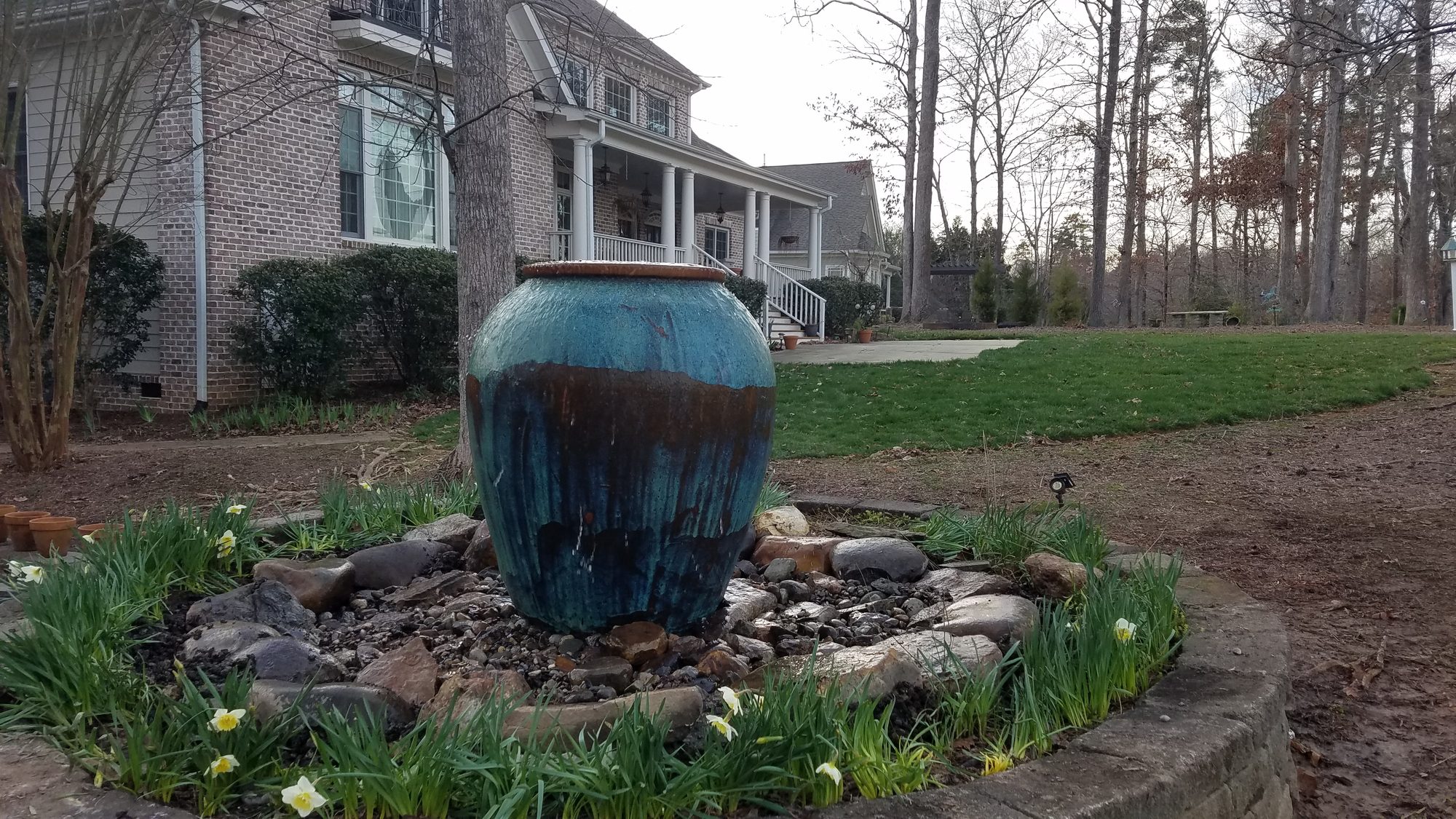 Glazed urn fountain on a stone base, built by iPond and Landscapes