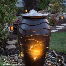 Lit ceramic urn fountain, built by iPond and Landscapes