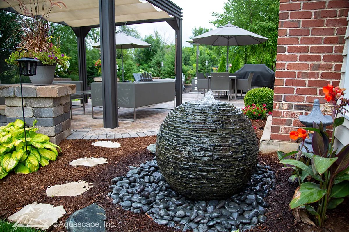 Slate sphere fountain by the patio, built by iPond and Landscapes