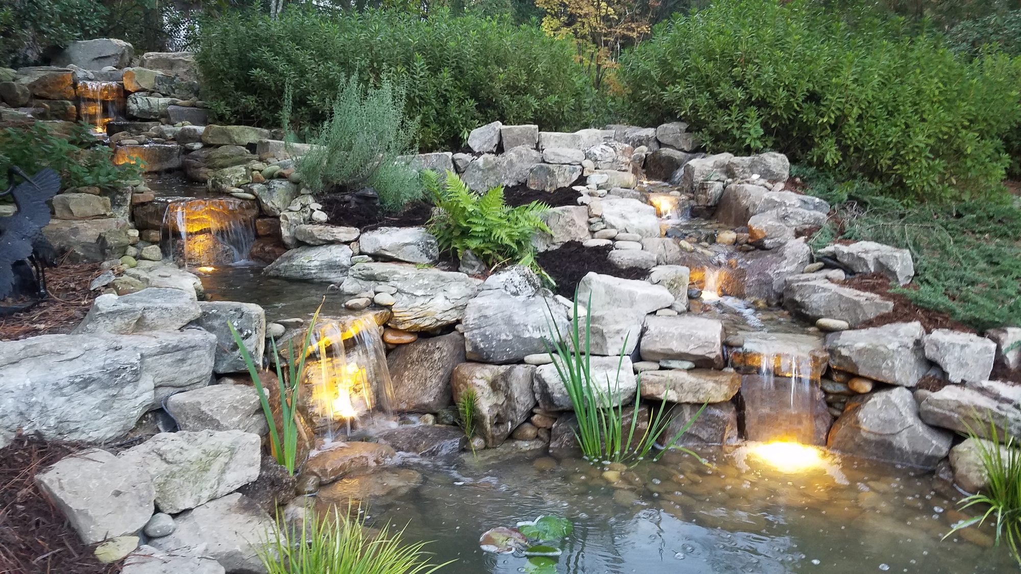 8x12 pond with double falls at dusk, Southern Pines, built by iPond and Landscapes