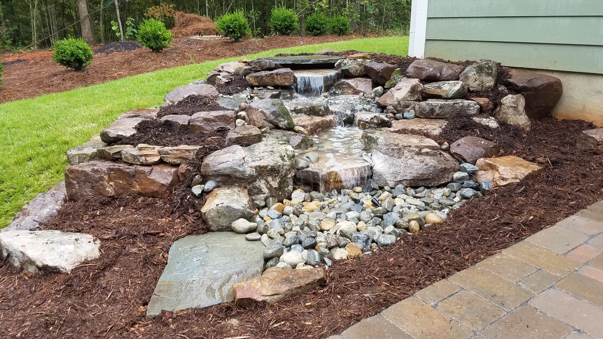 Pondless waterfall along the house, Chapel Hill, built by iPond and Landscapes