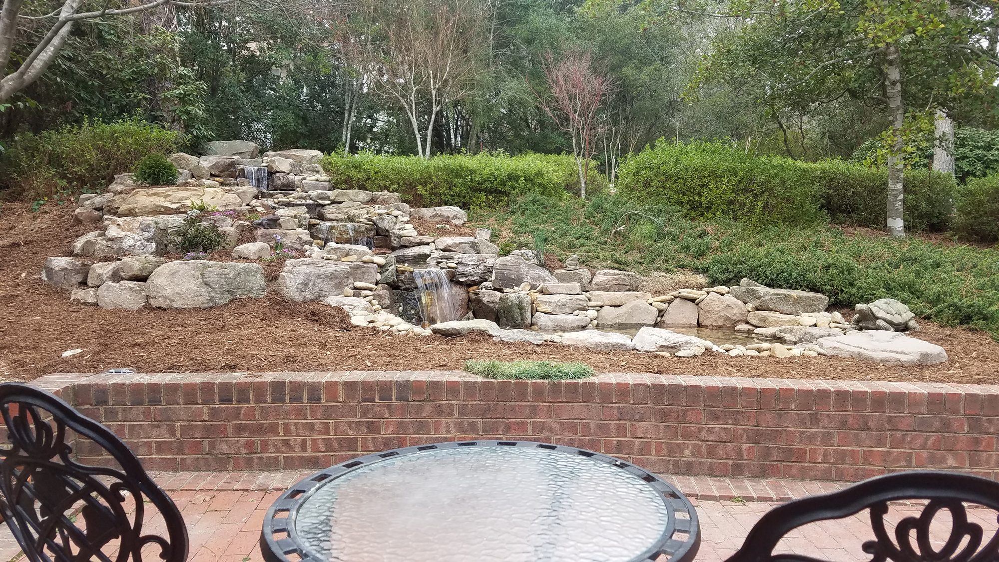 Waterfall pond by the patio, Southern Pines, built by iPond and Landscapes